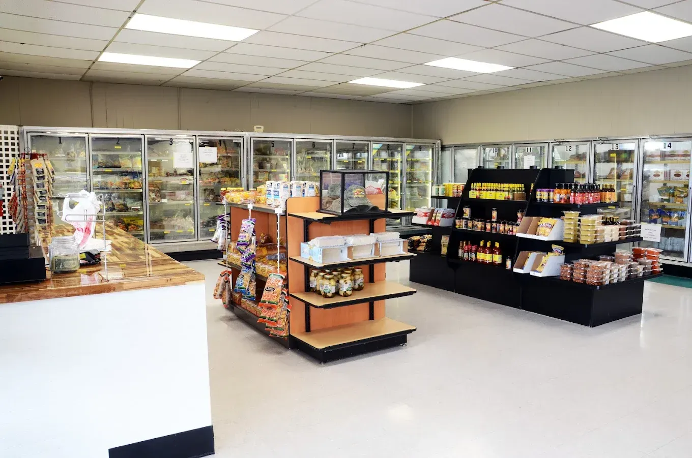 Convenience store interior with refrigerated cases and shelves stocked with snacks and drinks