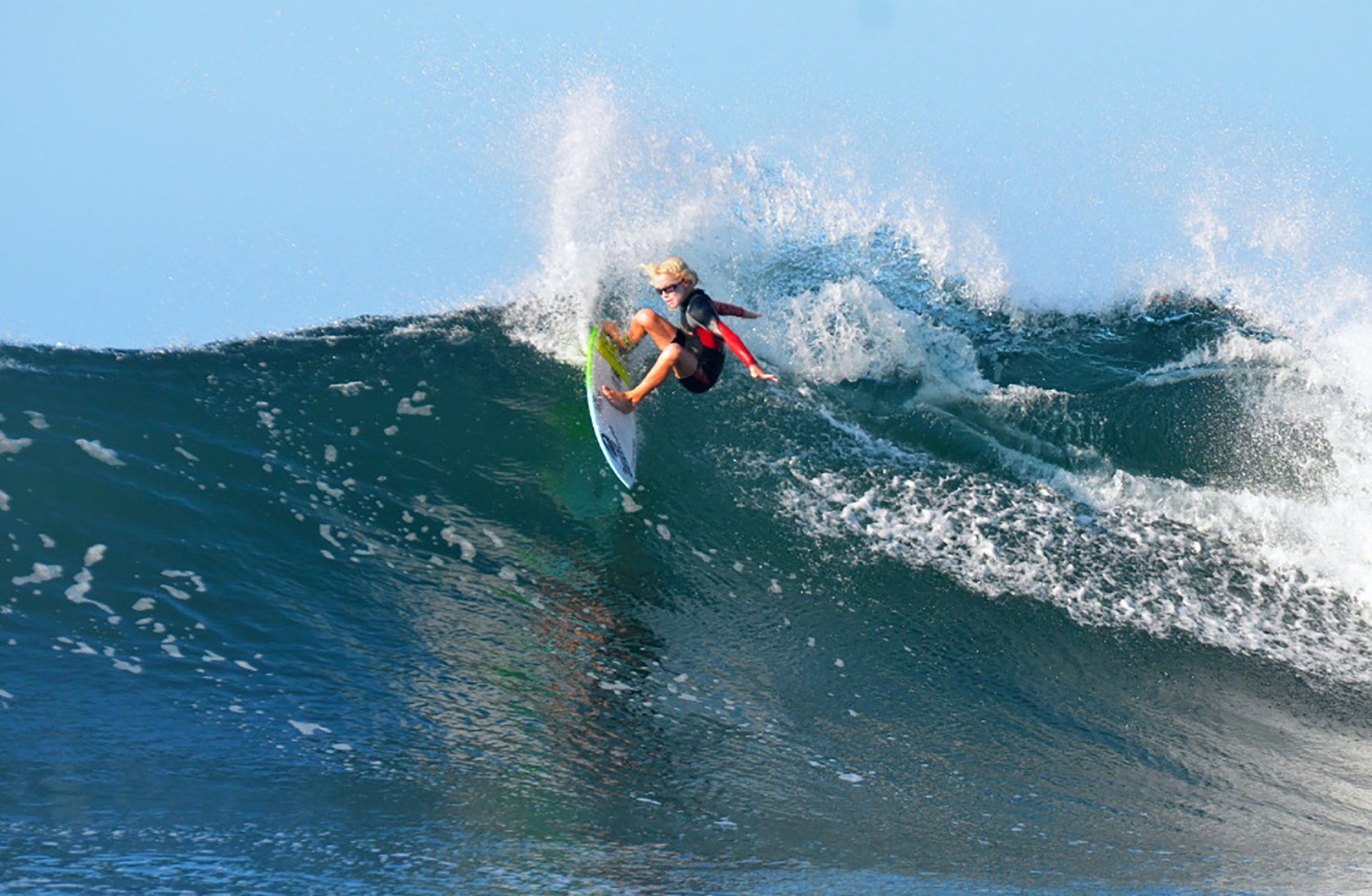 A person is riding a wave on a surfboard in the ocean.