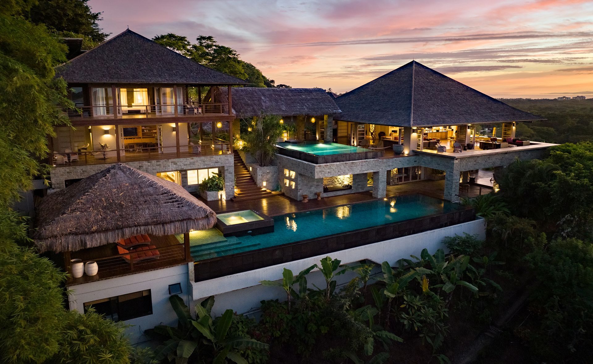 An aerial view of a large house with a swimming pool