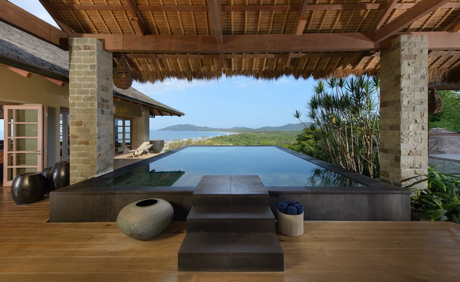 There is a large swimming pool in the middle of the house.