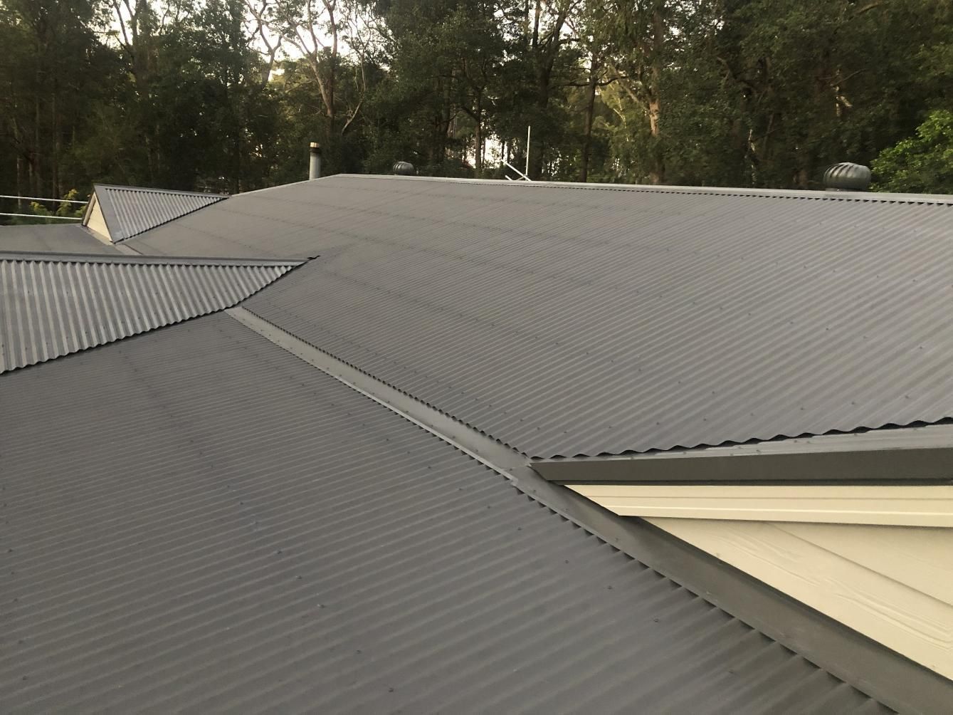 A Close Up Of A Roof Of A House With Trees In The Background — Glenroofing Pty Ltd In Taree, NSW
