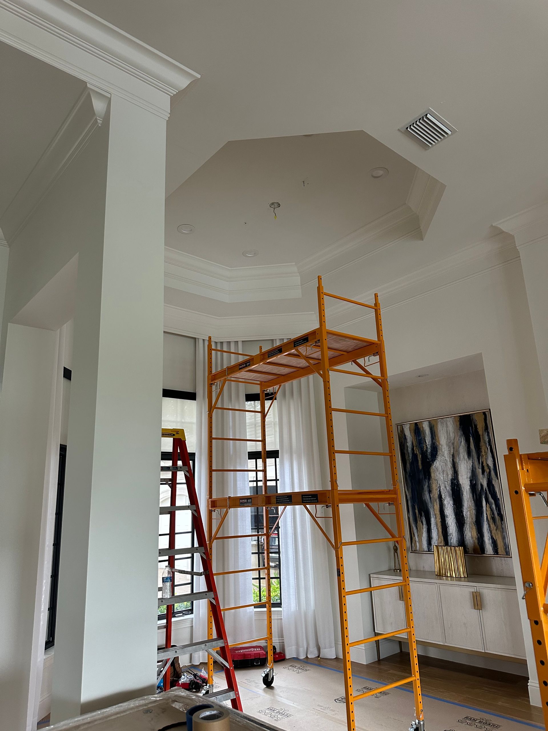 A room with a ladder and a scaffolding in it.