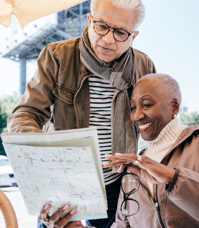 A man and a woman are looking at a map together.