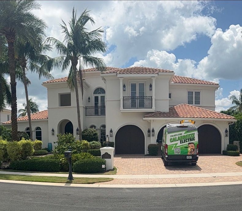 Two-story Mediterranean-style house with red tile roof and a green delivery van in the driveway.