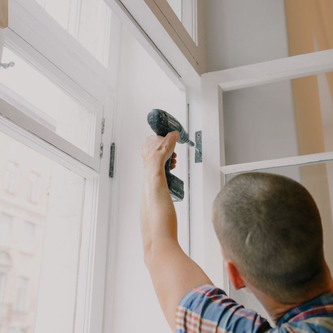 man fixing window