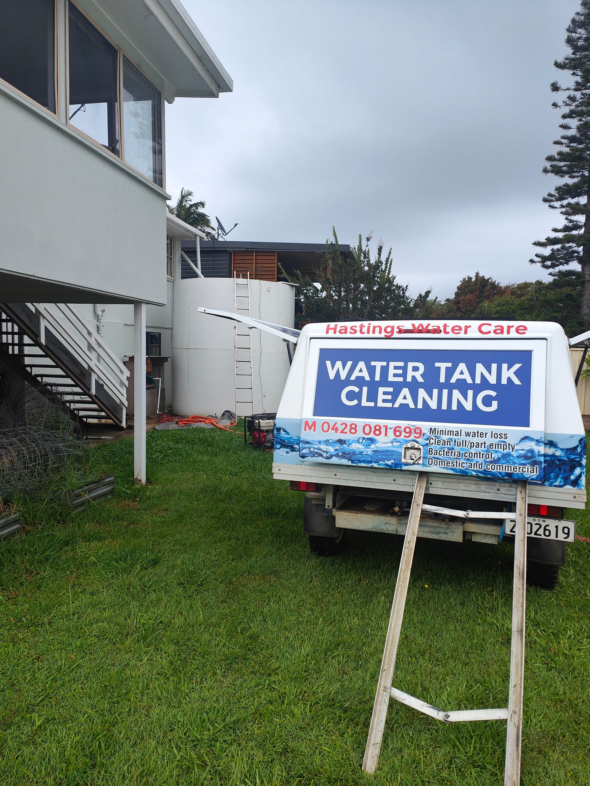 A branded work vehicle that's performing water tank maintenance - Hastings Water Care in Port Macquarie NSW