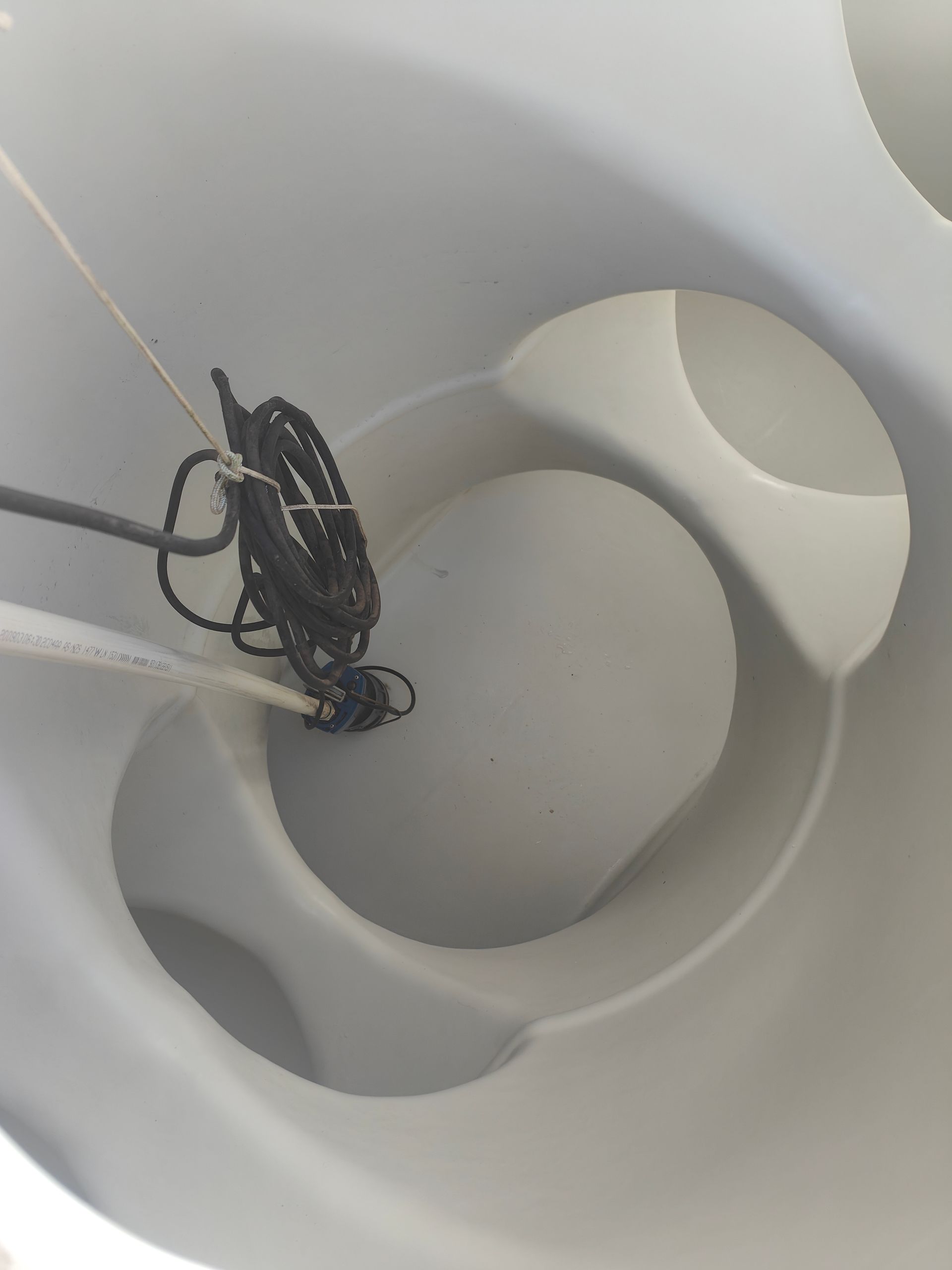 A black rope is hanging from a white object - Hastings Water Care in Port Macquarie NSW