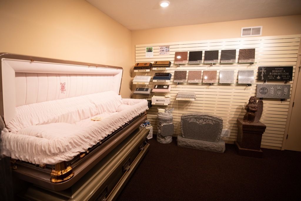 Showroom with a white upholstered sofa bed and wall-mounted fabric samples in a beige room