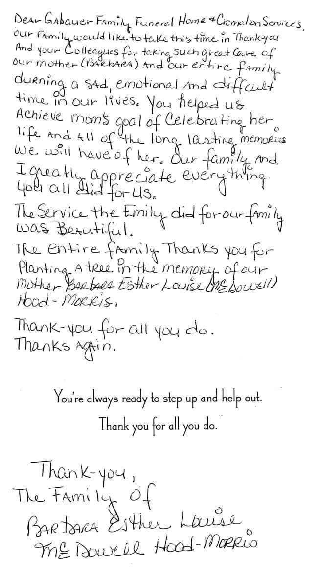 Blurry handwritten note on white paper with a small typed message near the bottom.