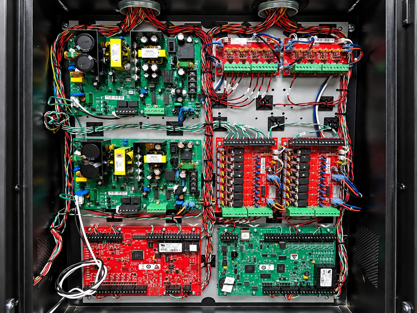 Electrical control panel with rows of blue modules, wiring, and terminal blocks inside a cabinet