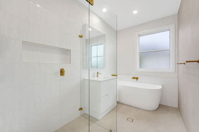 Bathroom renovation by Nique Building Central Coast — freestanding bath, glass shower and gold tapware