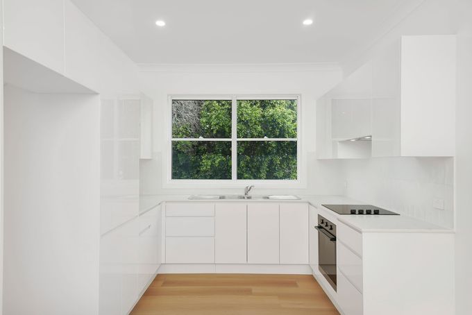 Home renovation hallway by Nique Building, Central Coast — timber floors and fresh white walls