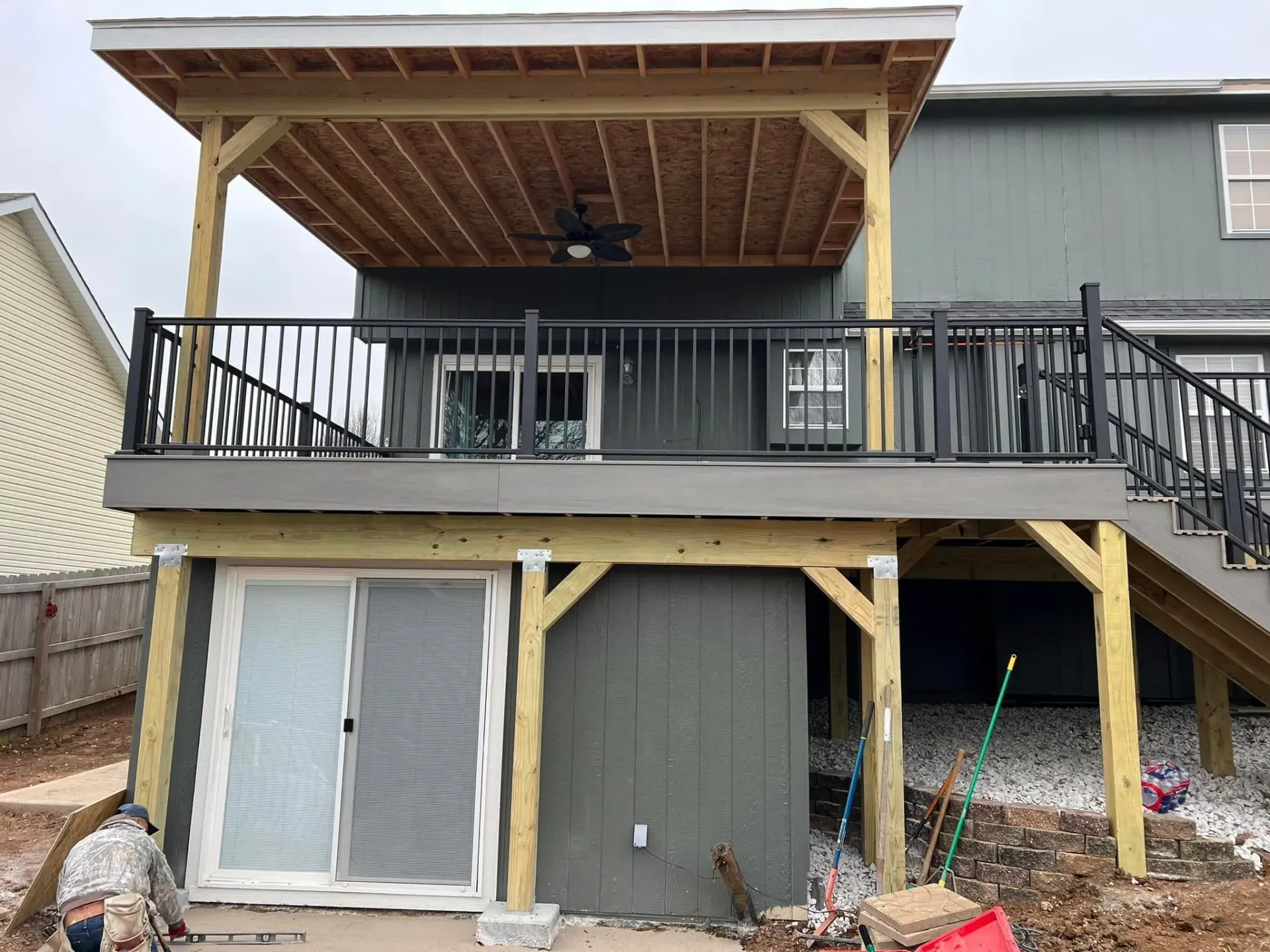 The back of a house with a large deck and stairs.