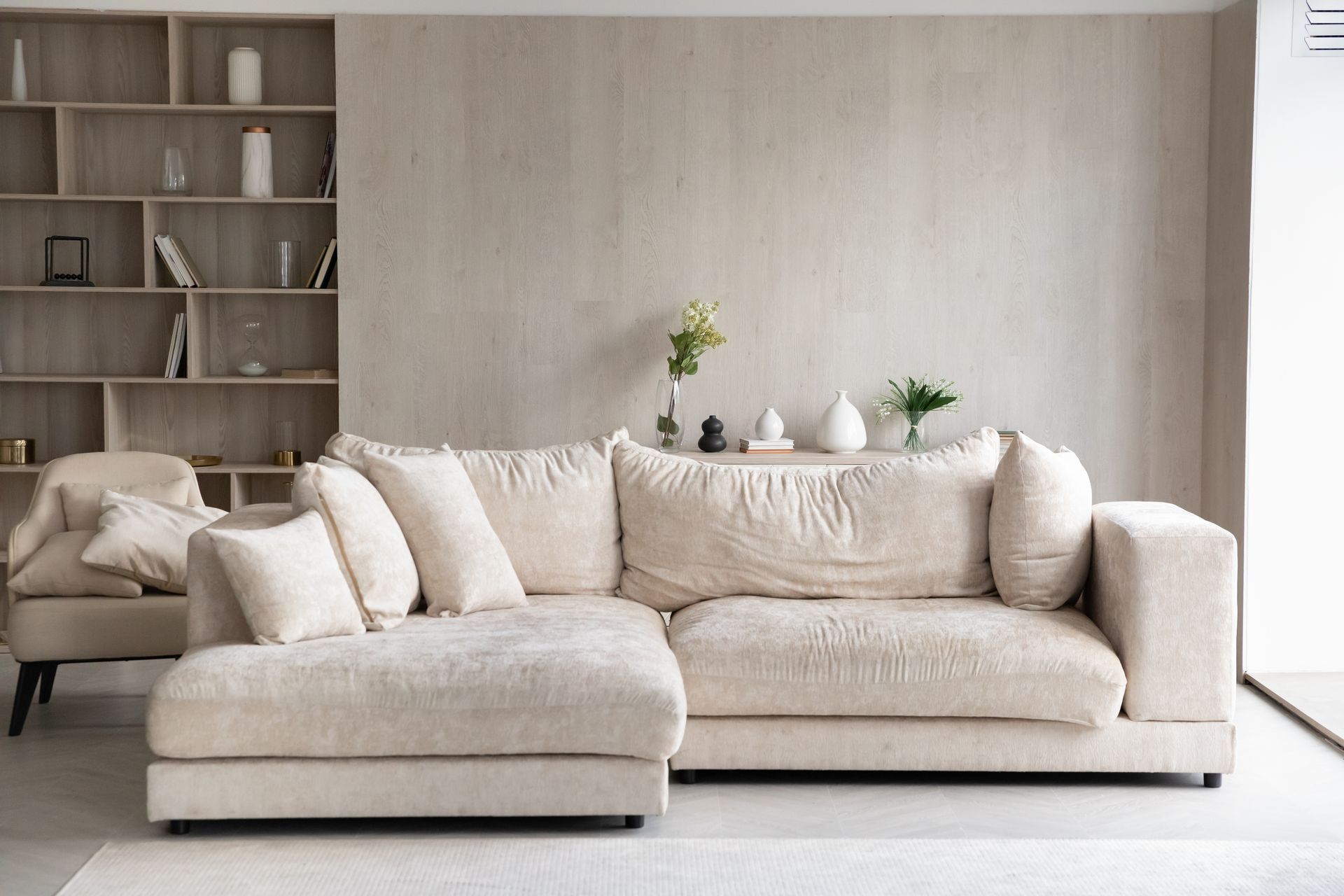 Modern furniture store sleek sectional sofa and armchair setup in a minimalist living room. Modern furniture store sleek sectional sofa and armchair setup in a minimalist living room.
