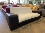 A white and brown couch is sitting in a living room.