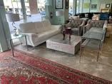 A living room filled with furniture and a rug.