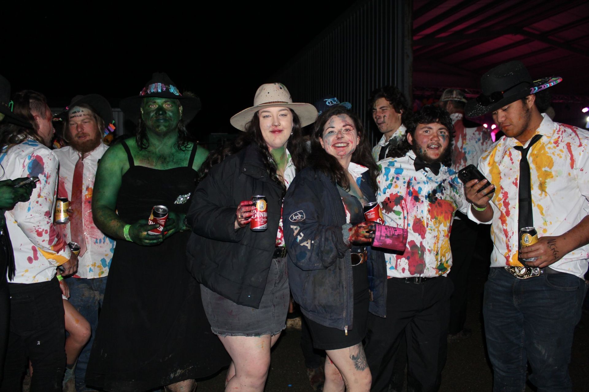 A group of people with coca cola cans in their hands