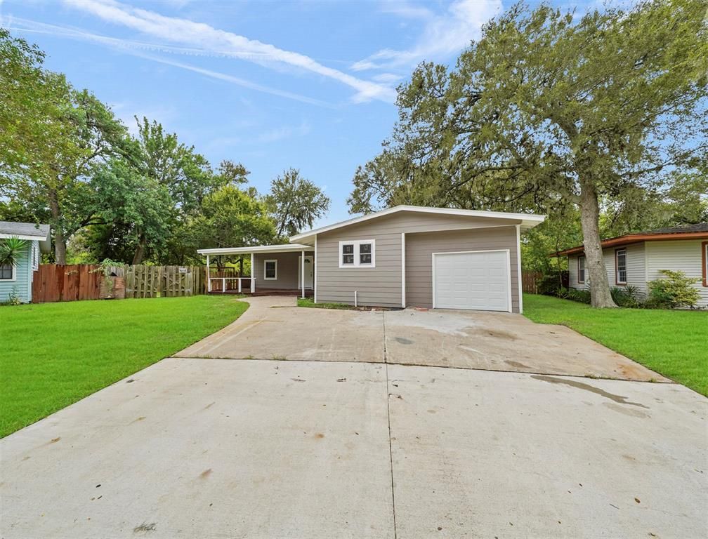 A house with a garage and a driveway in front of it