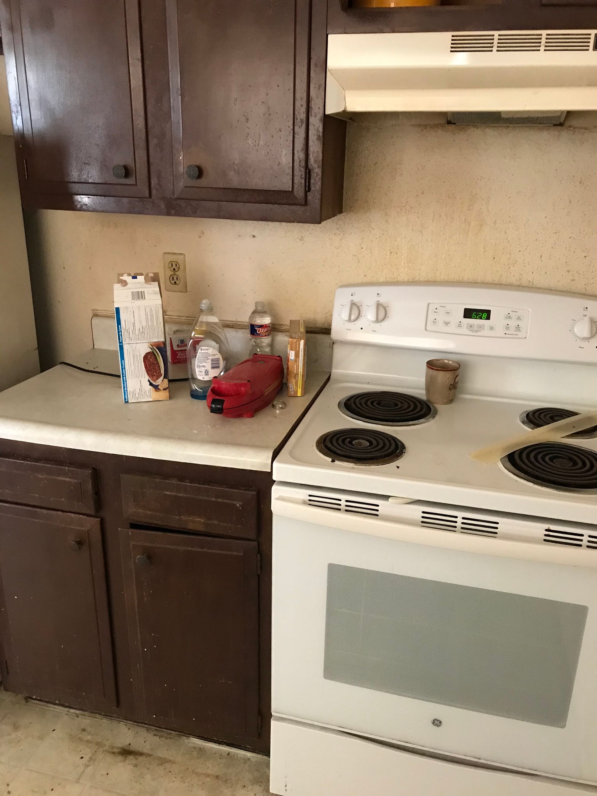 A kitchen with a stove , oven , and cabinets.