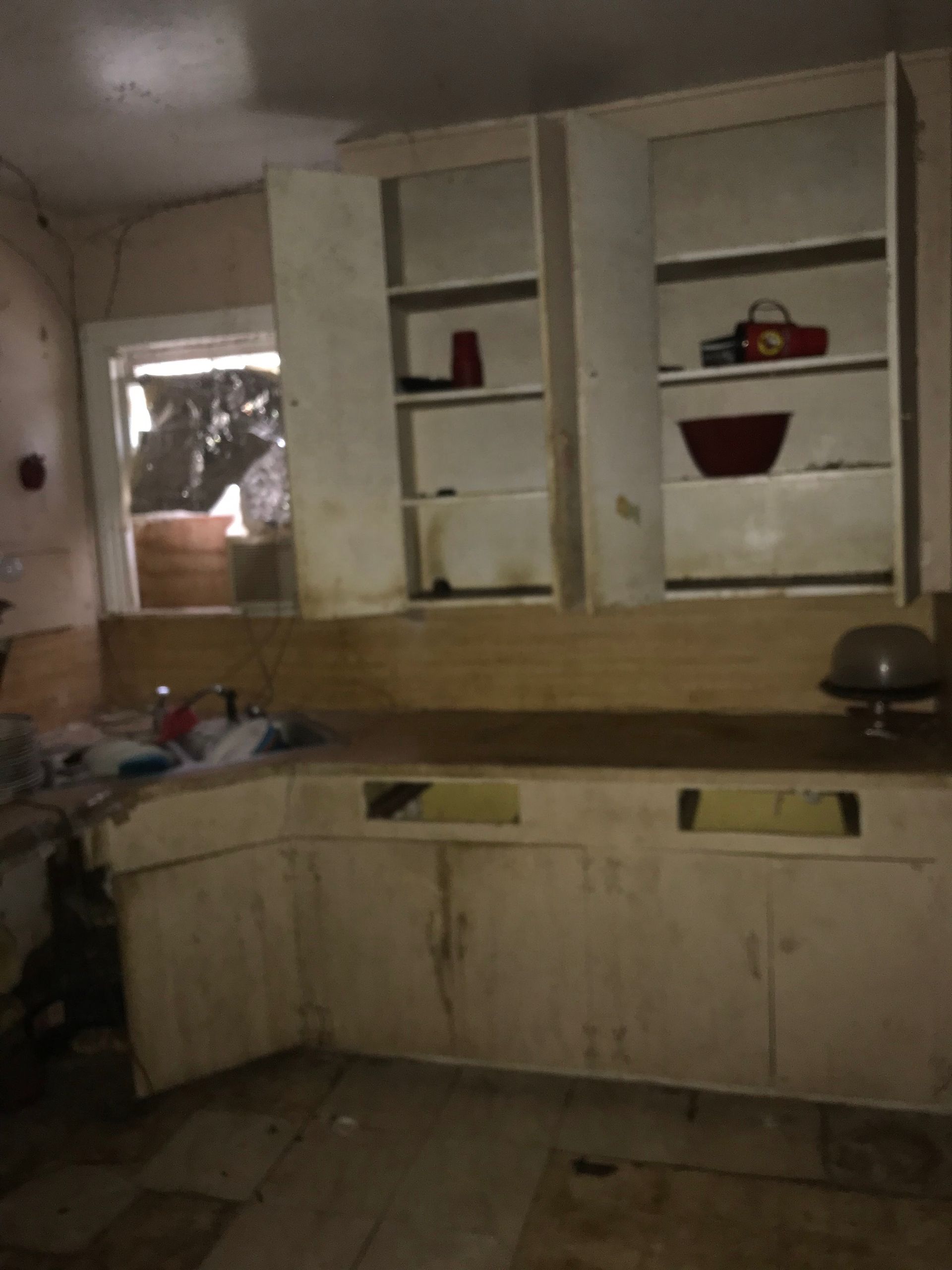 A kitchen with white cabinets and a sink