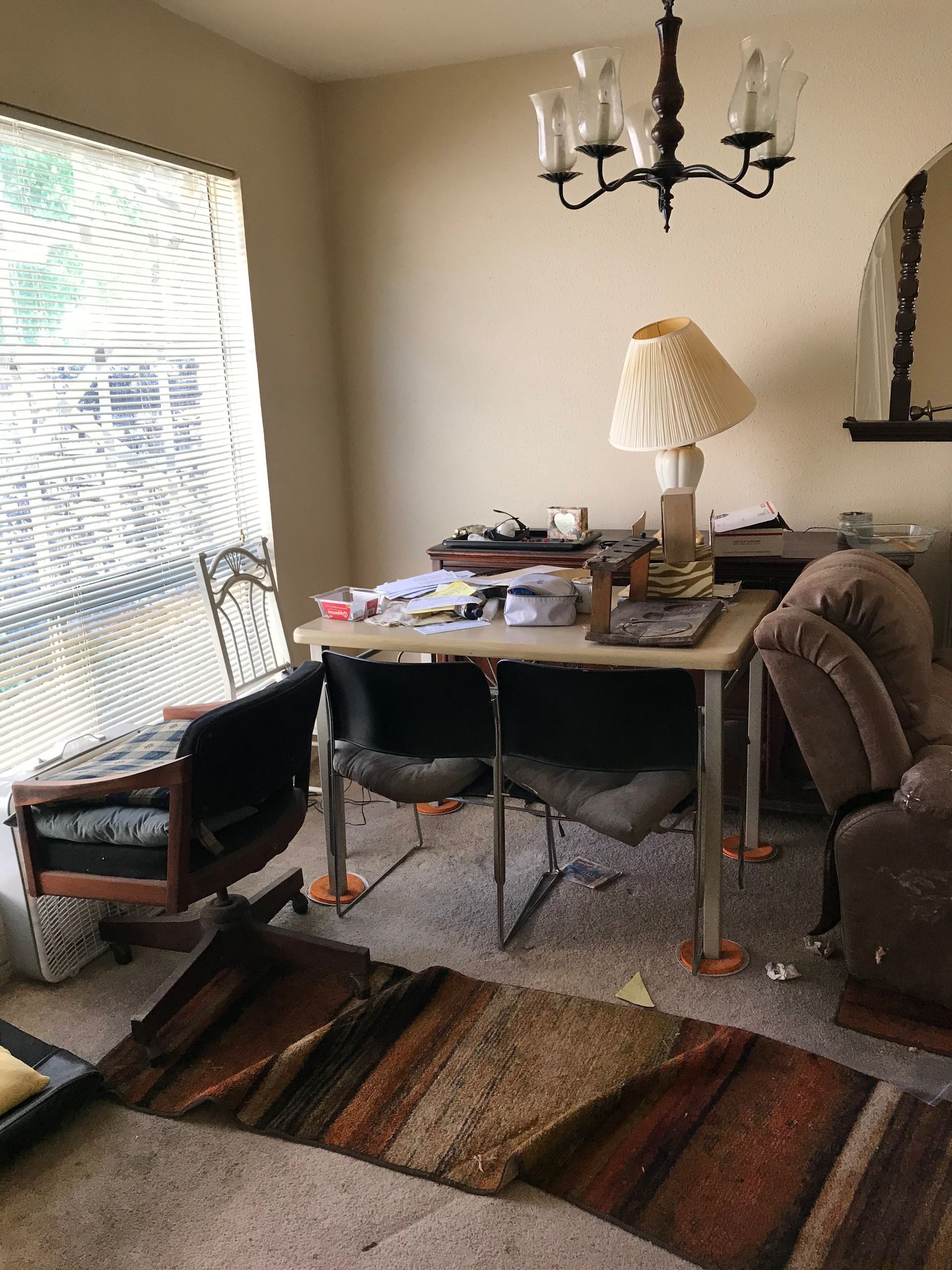 A living room with a table and chairs and a chandelier