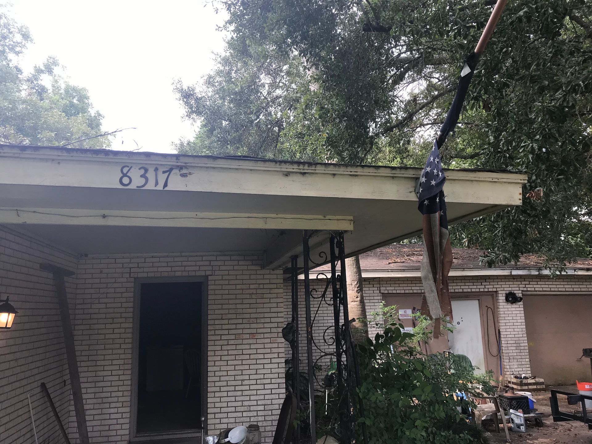 A brick house with a roof that has the number 8317 on it.