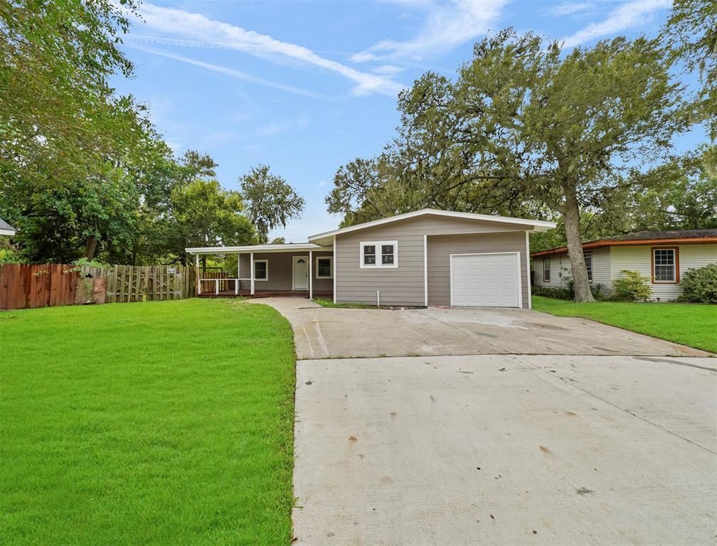 A house with a garage and a driveway in front of it