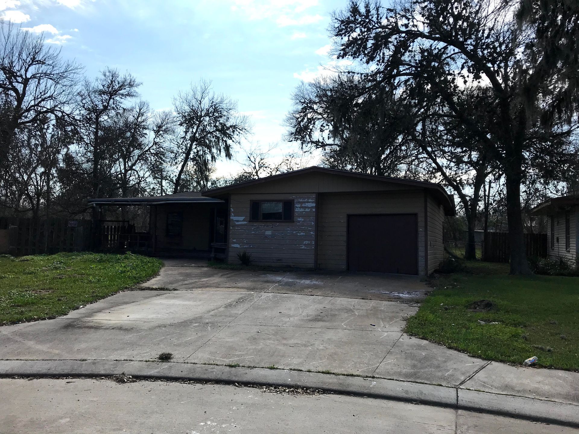 A house with a garage and a driveway in front of it