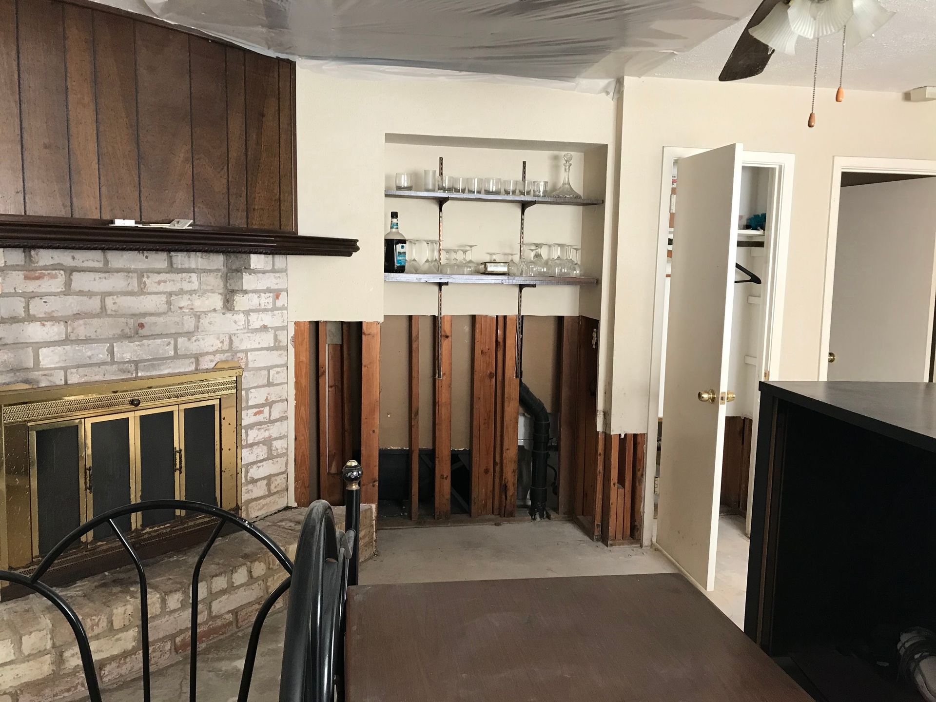 A living room with a fireplace and a bottle on a shelf
