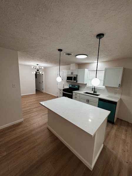 There is a large island in the middle of the kitchen.