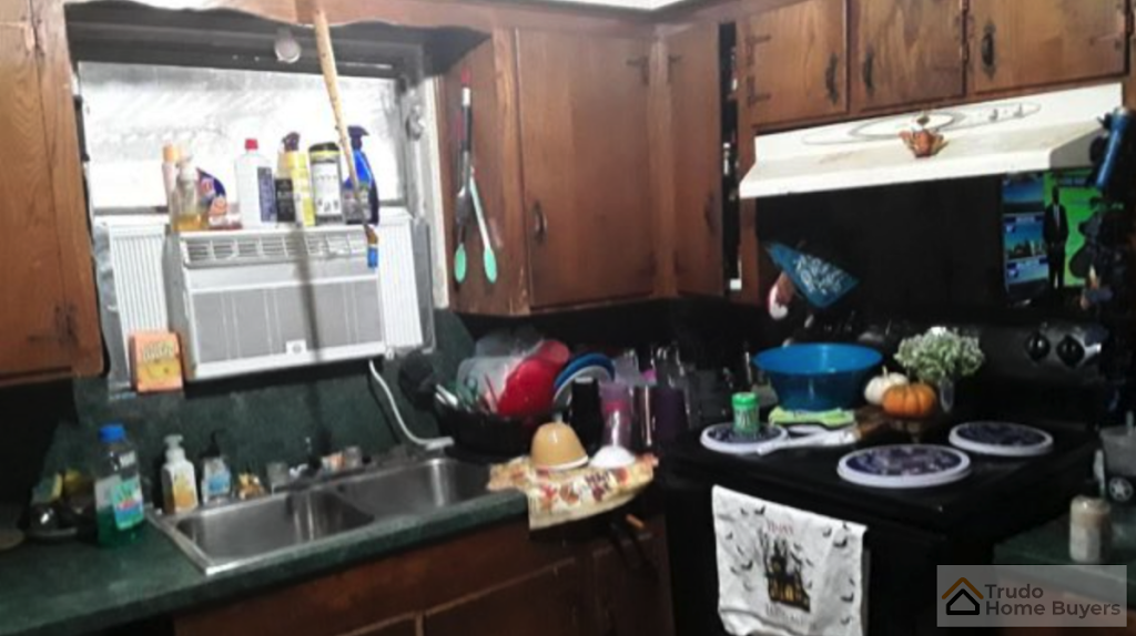 A kitchen with a stove top oven and a sink