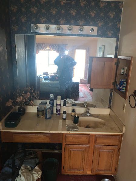 A bathroom with two sinks and a large mirror.