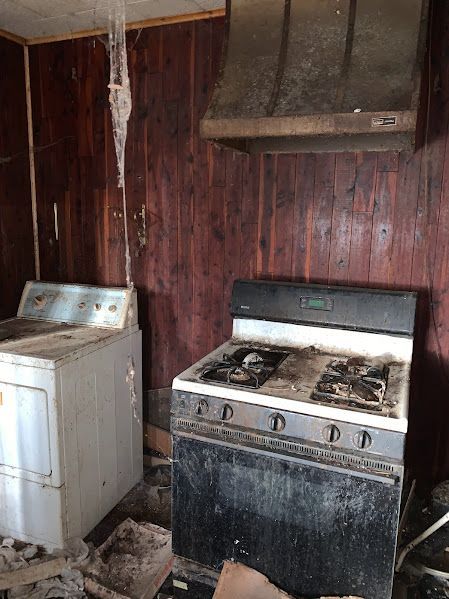There is a stove and a dryer in the room.