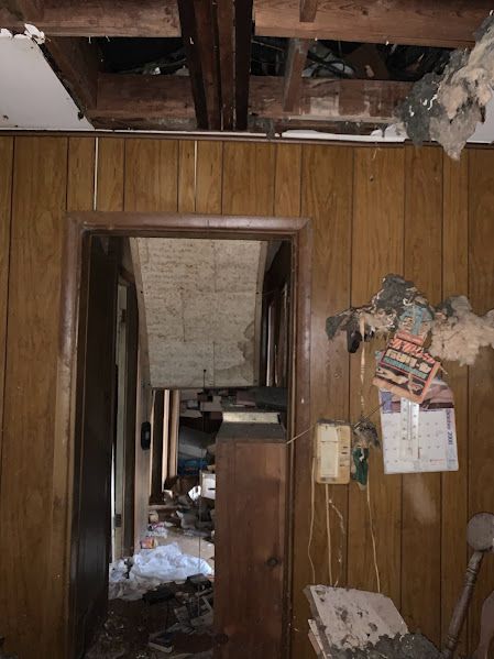 A room with wood paneling and a calendar on the wall.