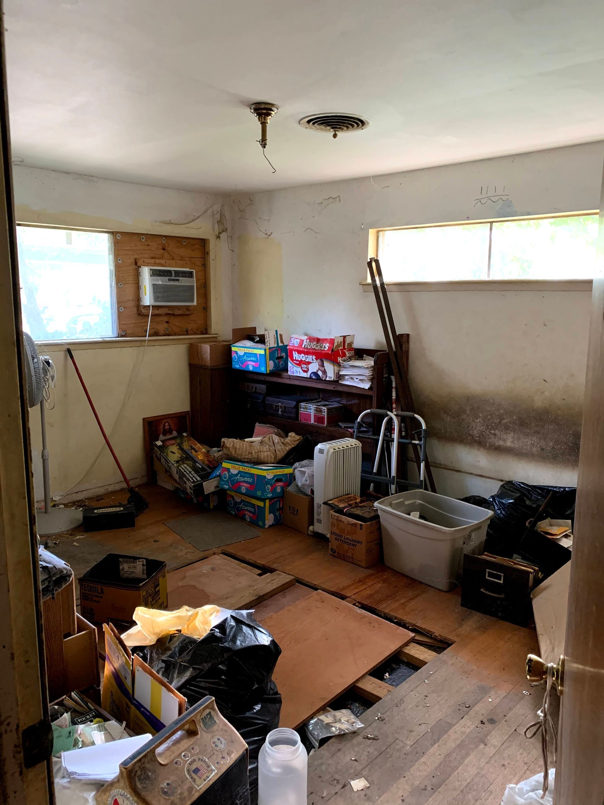 A room filled with lots of junk and boxes.
