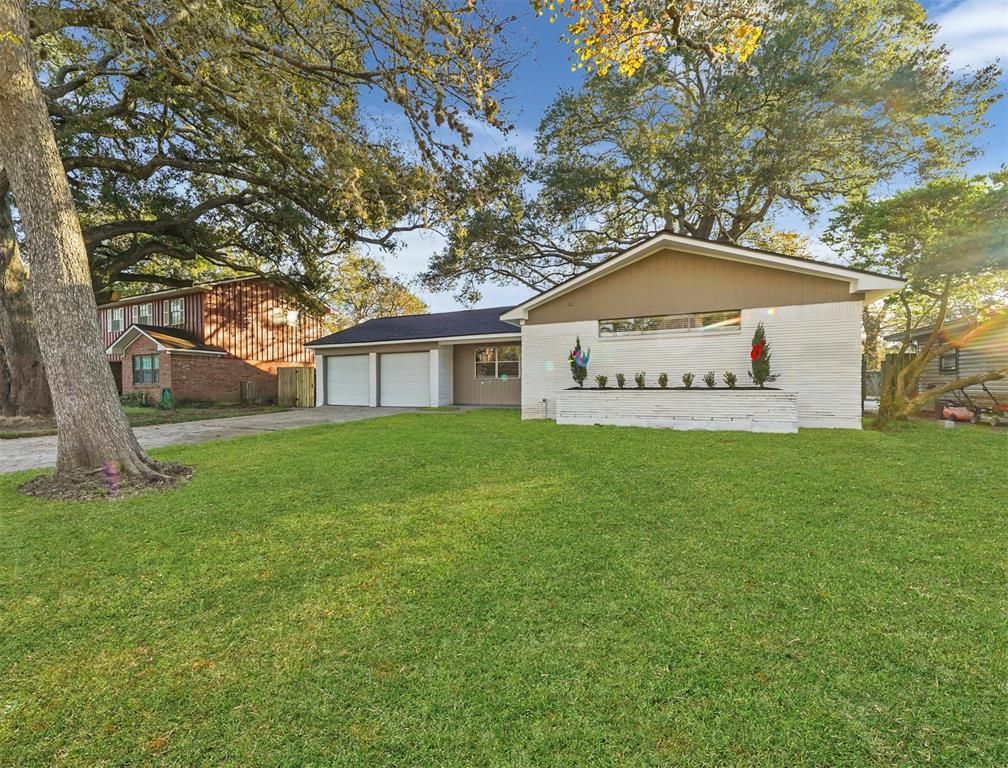 A house with a large lawn in front of it is for sale.