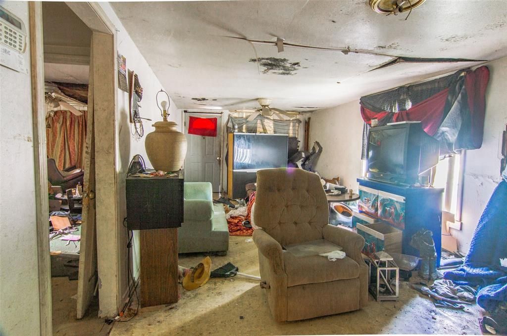 A living room filled with furniture and a television.