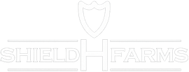 White Shield Farms logo with a shield and text on a light background