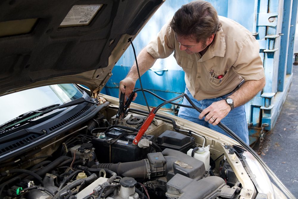 A Man Is Working Under The Hood Of A Car — Tamworth Muffler Man In Quirindi, NSW