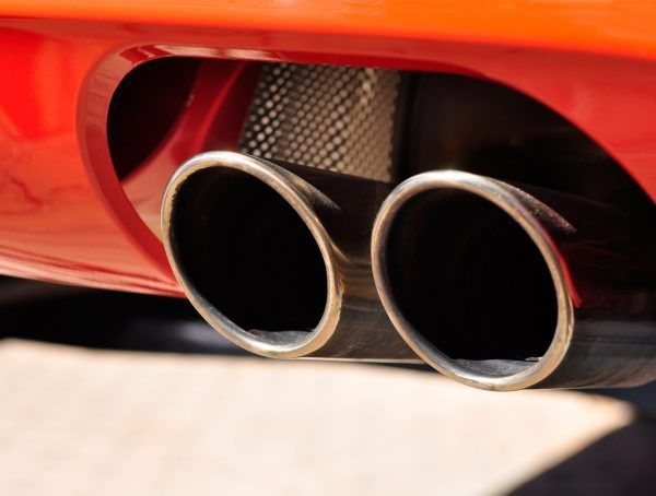 A Close Up Of A Red Car Exhaust Pipe — Tamworth Muffler Man In Tamworth, NSW