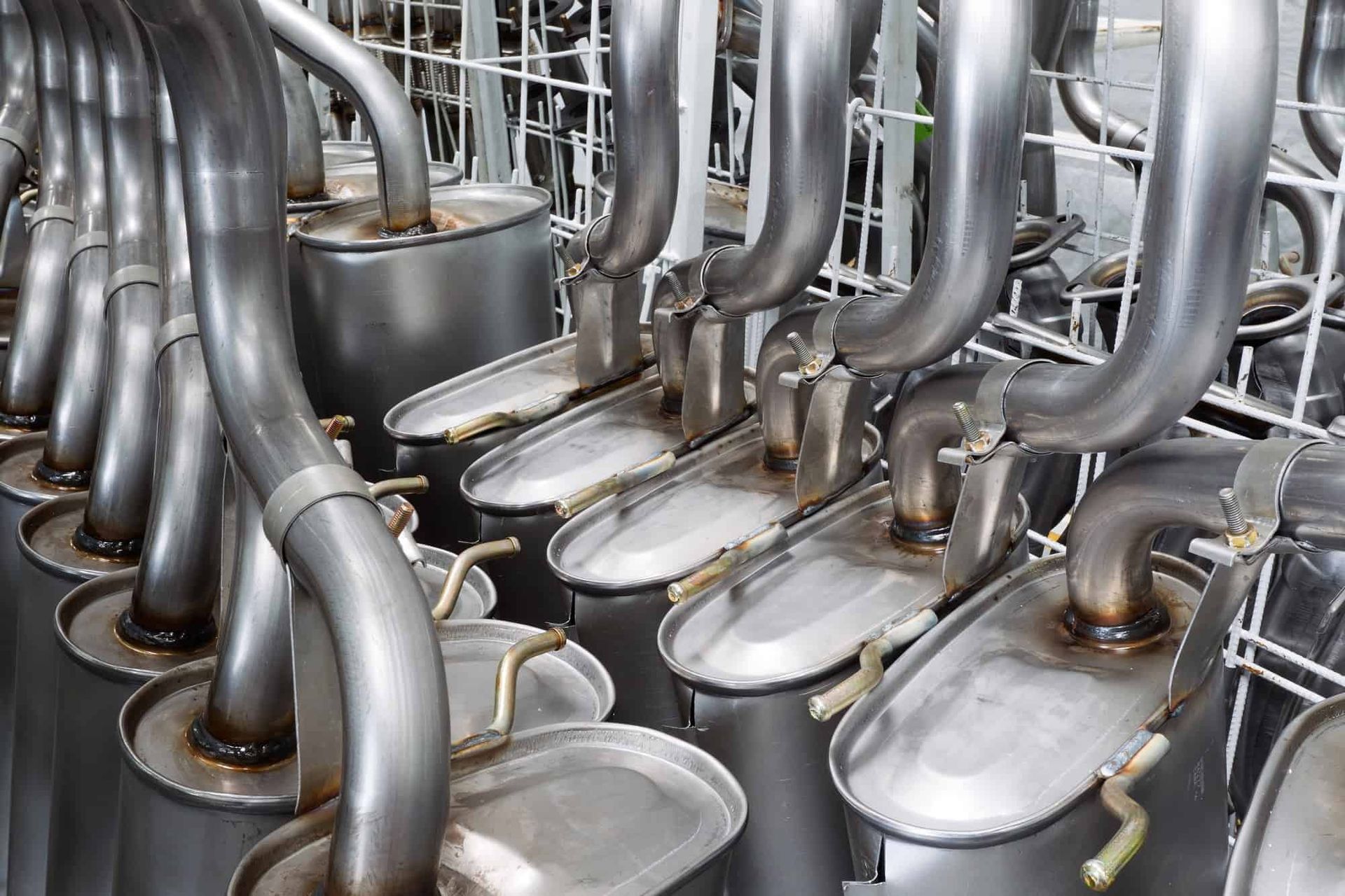 A Bunch Of Exhaust Pipes Are Lined Up In A Row — Tamworth Muffler Man In Tamworth, NSW