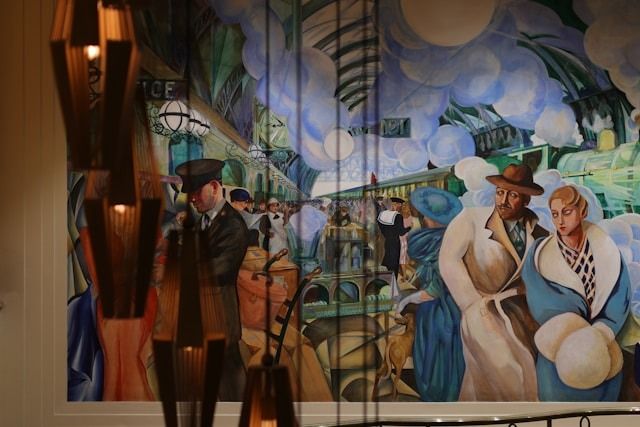 Abstract mural of elegantly dressed figures under a cloudy sky in a tiled indoor space