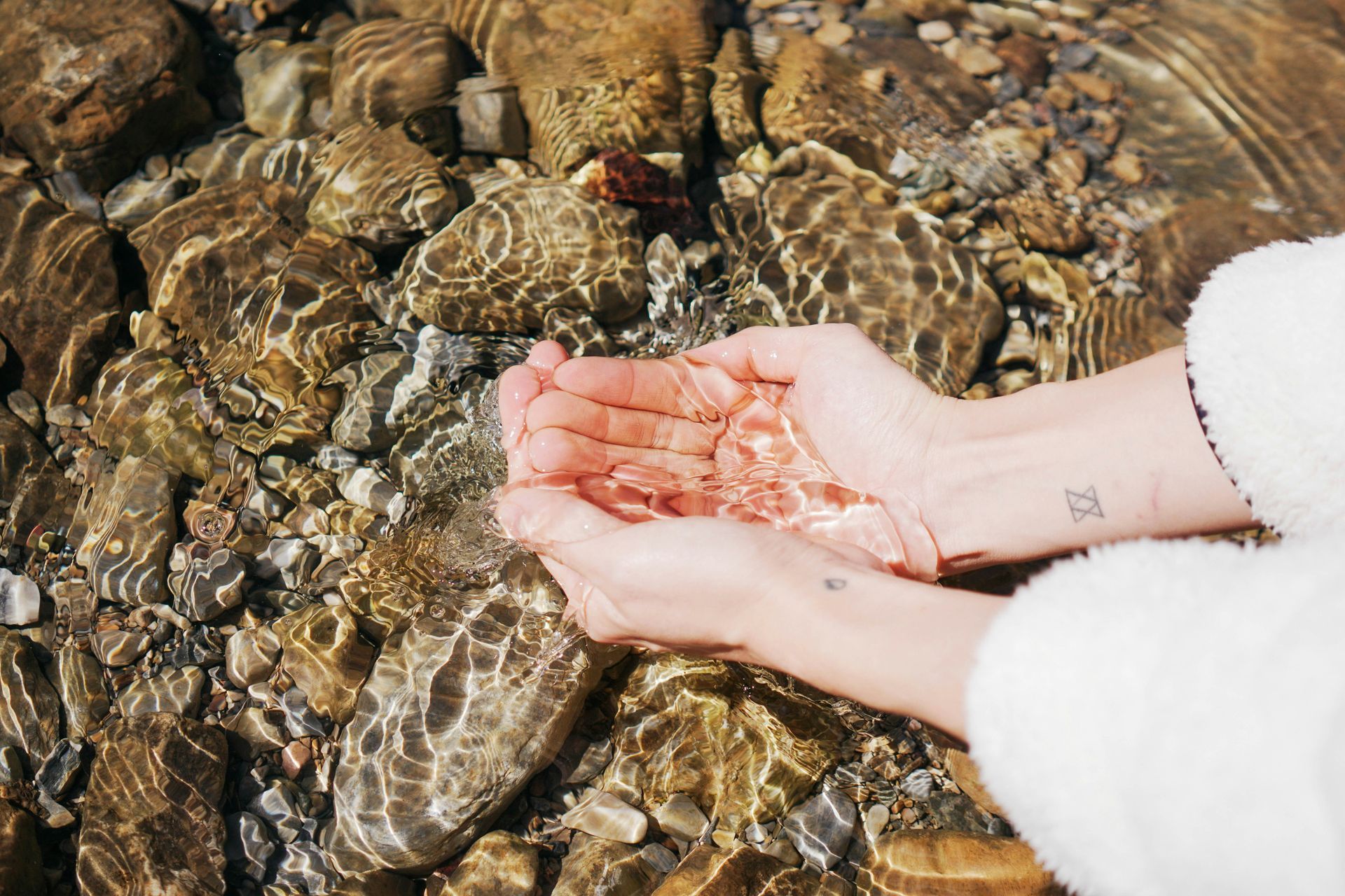 Person holding water in cupped hands as a metaphor for holding complexity in binge eating recovery 