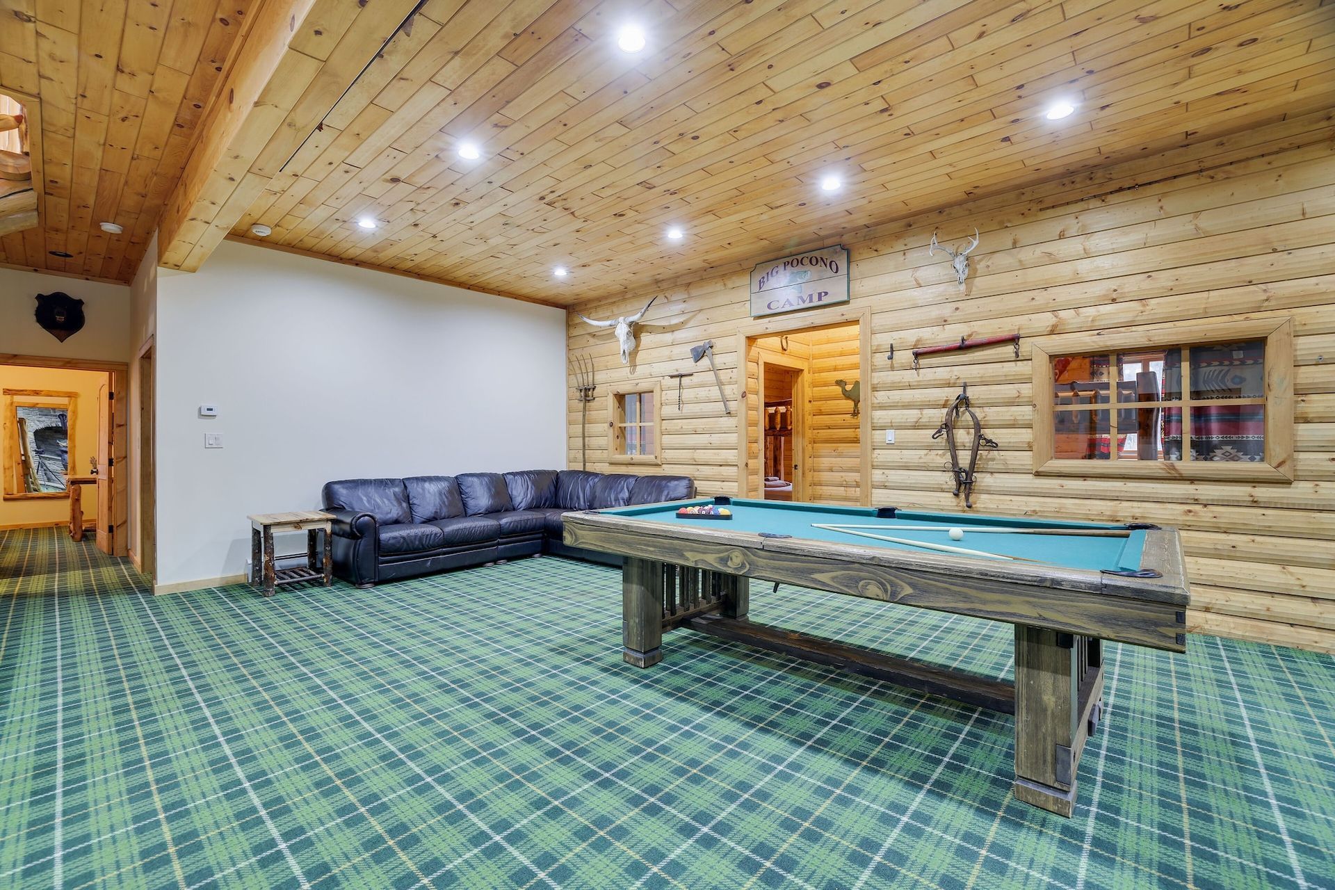 There is a pool table in the middle of the room.