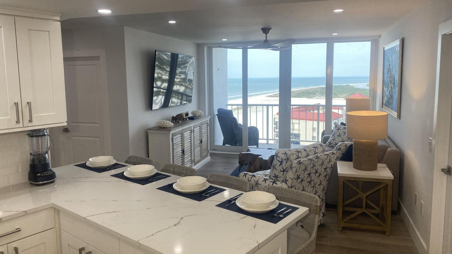 A kitchen and living room with a view of the ocean.