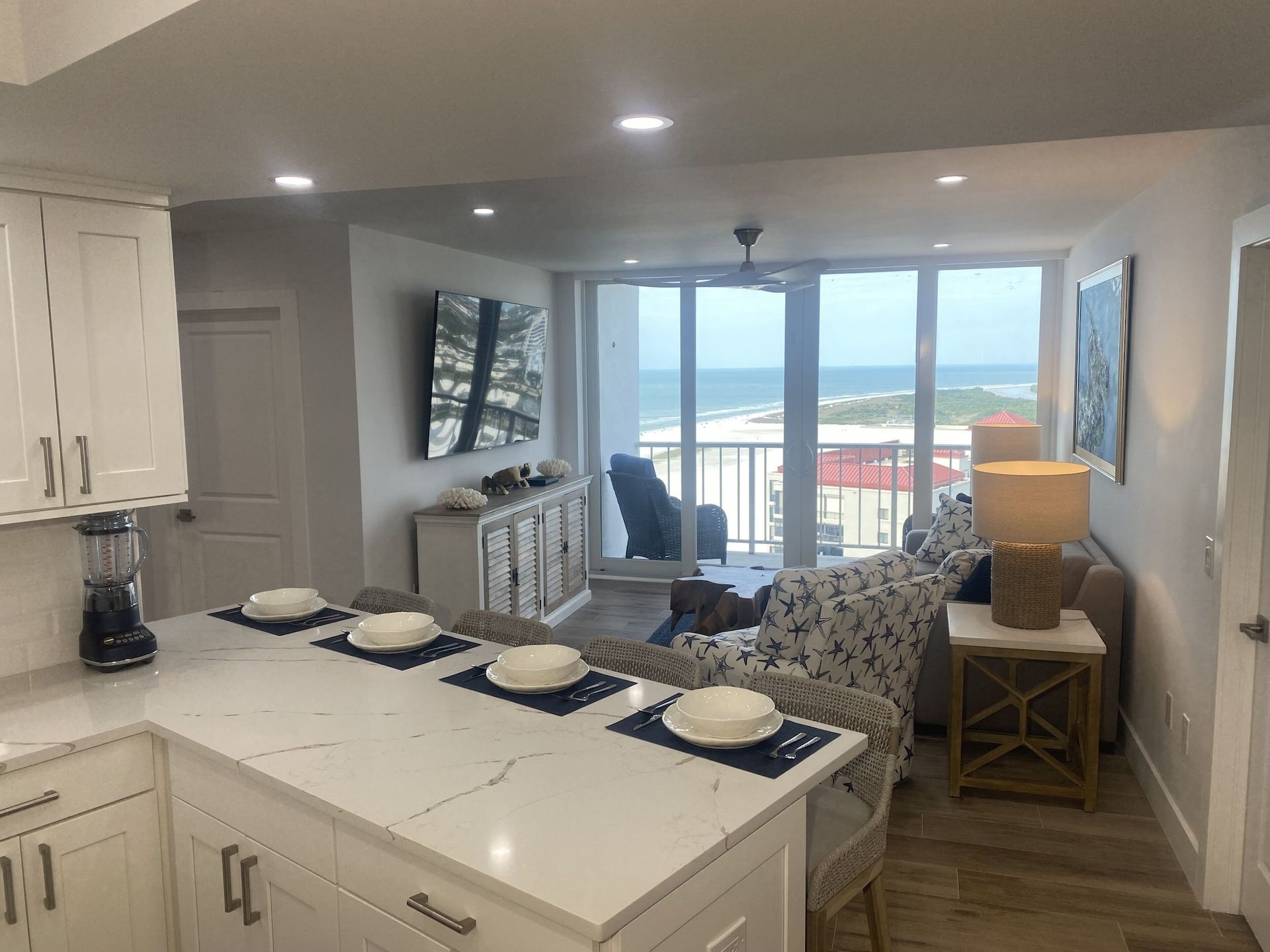 A kitchen and living room with a view of the ocean.