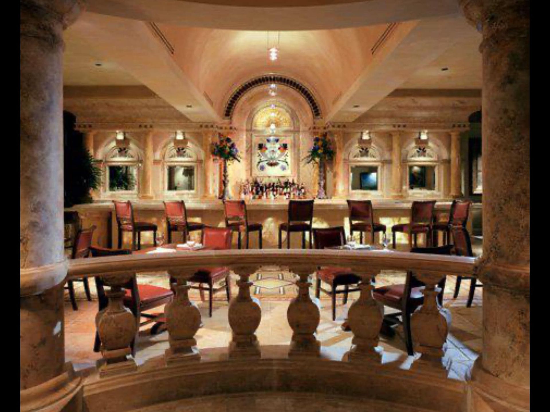 A large room with tables and chairs and a balcony