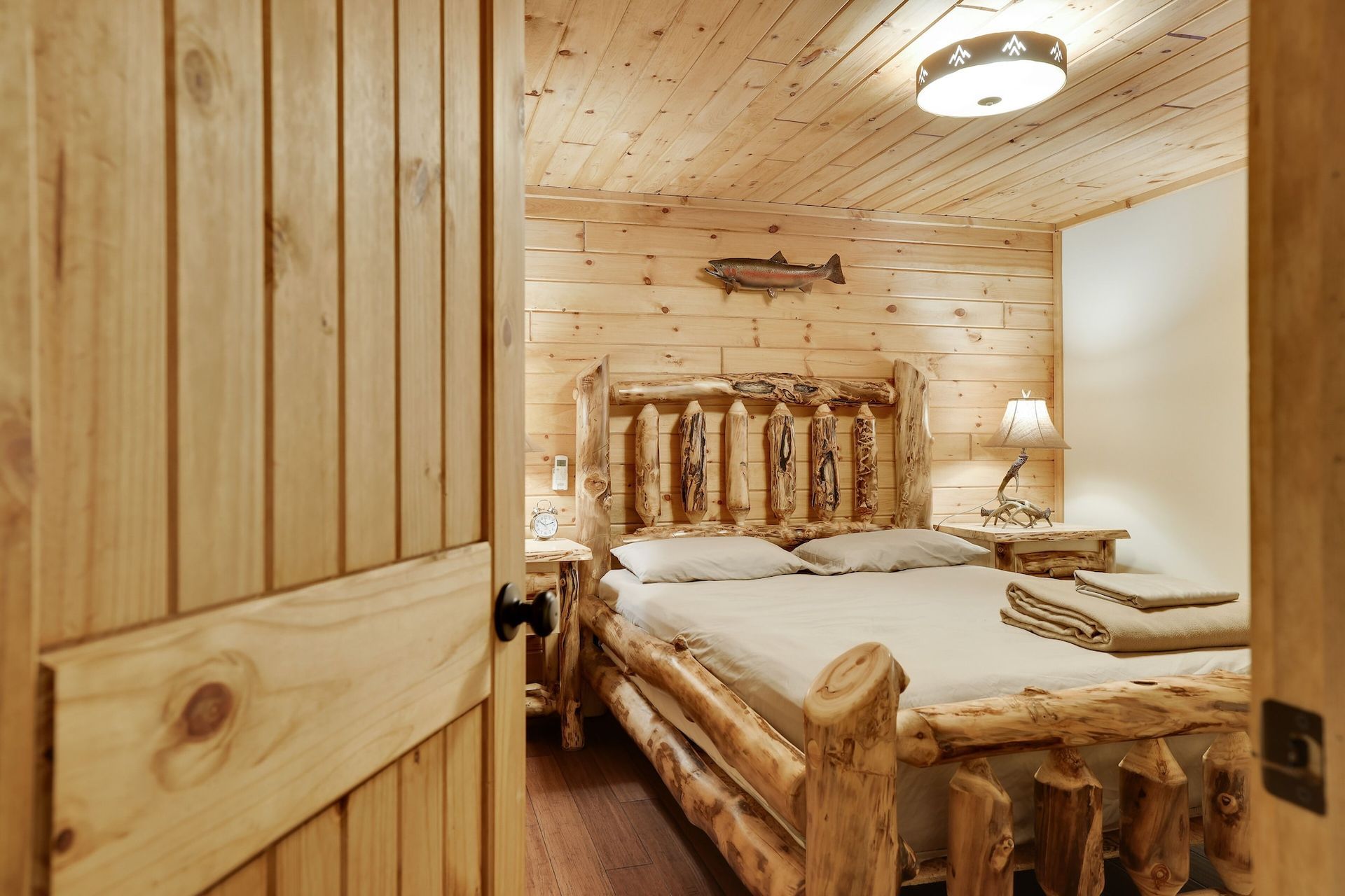 A bedroom with a log bed and a wooden door