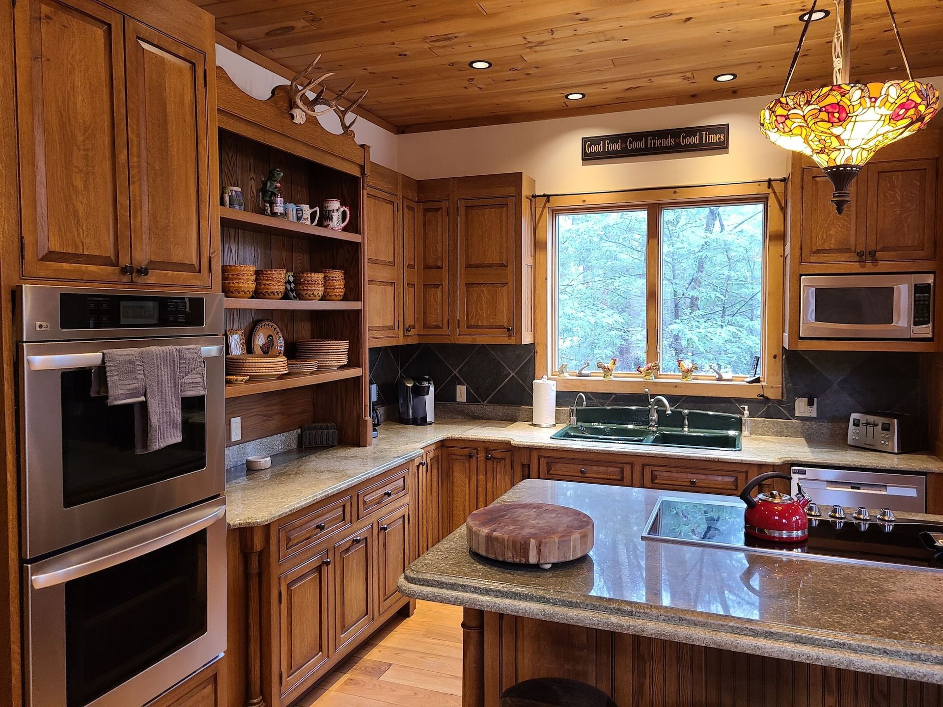 A kitchen with wooden cabinets and stainless steel appliances