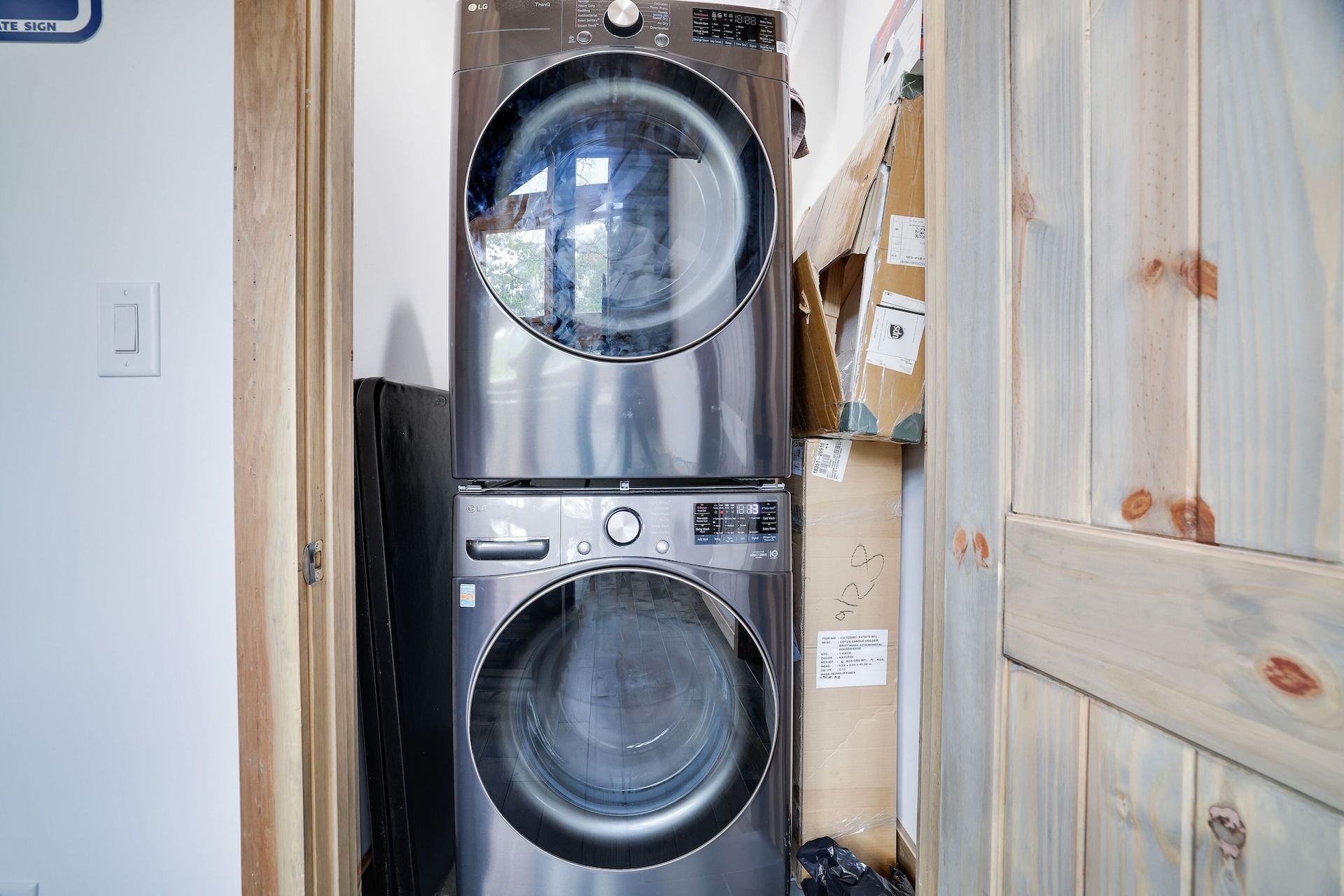 A washer and dryer are stacked on top of each other in a laundry room.